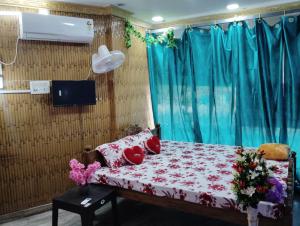 a bedroom with a bed with flowers on it at MAMATA CROWN Inn in Bhubaneshwar