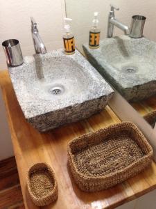 a bathroom with two sinks on a wooden counter at Tranquility Guest House in Srīrangam
