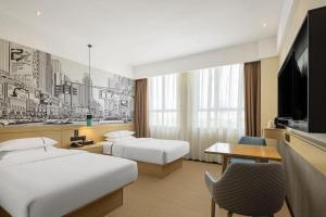 a hotel room with two beds and a television at City Comfort Inn Liuzhou Longtan Park Ma'anshan Baiyun in Liuzhou +162 photos
