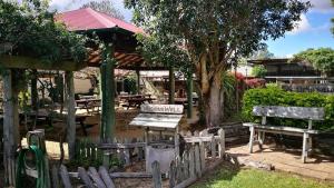 a park with benches and a pavilion with a table at The Hideaway Hotel in Tiaro