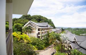 a view from a balcony of a building with trees at Raffy White Boracay in Boracay