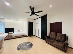 a living room with a ceiling fan and a couch at 3KM to UTAR Sungai Long Party House 45Pax 20Car in Kajang +43 photos