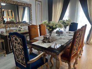 a dining room with a table with chairs and a mirror at CDA Park Enclave a tastefully furnished property ! in Islamabad