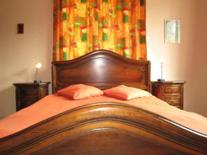 a wooden bed with two pillows in a bedroom at Tranquil Escape, Sourbrodt in Waimes