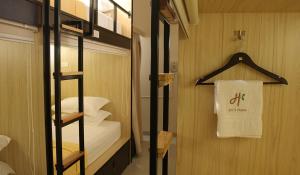 a room with a bed and a towel on a wall at dric's House in Tanjungpandan