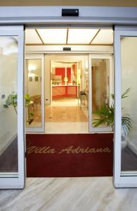 a glass door of a building with the words raisin architecture at Hotel Villa Adriana in Monterosso al Mare