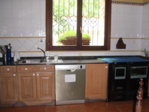 a kitchen with a sink and a stove and a window at Casa Rural Ugarte Ojacastro in Ojacastro