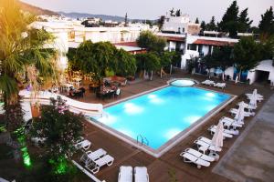 an overhead view of a large swimming pool with lounge chairs at Delfi Hotel Spa & Wellness Center in Bodrum City