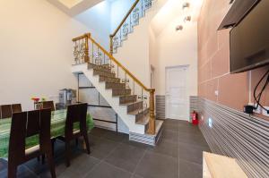 a living room with a staircase and a table at Good Mood Cottage in Hengchun South Gate