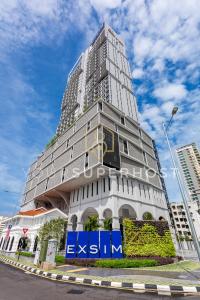 a tall building with a sign in front of it at 22 Macalisterz by YourSuperhost in George Town