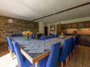 a large room with a long table and blue chairs at Spacious Waimes Villa in Waimes +46 photos