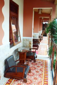 a row of chairs and tables in a building at Hostel 1001 Malam Malioboro in Jetis