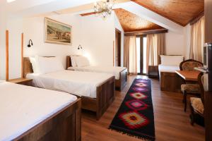 a hotel room with two beds and a table at Villa Starova in Berat