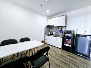 a room with a table and chairs and a kitchen at Royal Apartment in Dien Ban