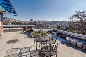 Un patio con una mesa y sillas en un tejado. en Bright, Airy Itaewon Rooftop, 10 min to Myeongdong, en Seúl