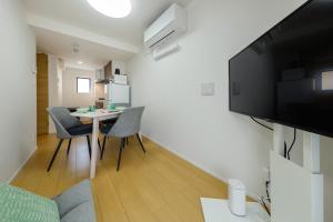 a small living room with a table and chairs at Oakville Nezu by Tranova in Tokyo