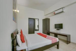 a bedroom with a bed and a television at Hotel O Dream View in Gurgaon