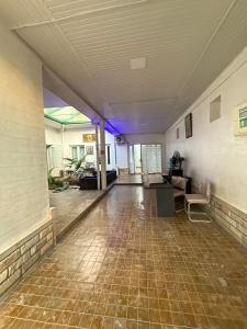 an empty room with a tile floor and purple lighting at Hovli Hostel in Salor Bekati
