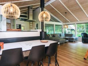 a kitchen and living room with a table and chairs at 4 star holiday home in Bindslev in Bindslev