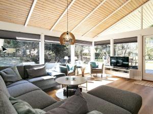 a living room with a couch and a tv at 8 person holiday home in Bindslev-By Traum in Bindslev +45 photos
