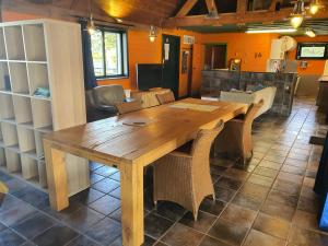 a wooden table and chairs in a room at Vakantie verblijf in Bredene