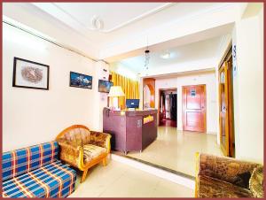 a living room with a couch and a chair at HOTEL You & Me Near Mall Road & NAINI LAKE - Free Wifi & Room Service With Parking Facilities - Hygiene and Spacious Room - The Best Hotel with Mountain Views - Best Hotel In Nainital in Nainital