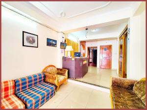 a living room with a couch and two chairs at HOTEL You & Me Near Mall Road & NAINI LAKE - Free Wifi & Room Service With Parking Facilities - Hygiene and Spacious Room - The Best Hotel with Mountain Views - Best Hotel In Nainital in Nainital