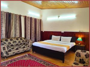 a bedroom with a bed and a couch at HOTEL You & Me Near Mall Road & NAINI LAKE - Free Wifi & Room Service With Parking Facilities - Hygiene and Spacious Room - The Best Hotel with Mountain Views - Best Hotel In Nainital in Nainital