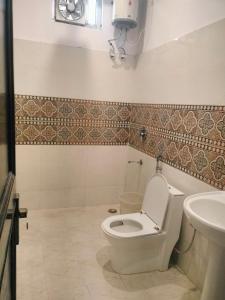 a bathroom with a toilet and a sink at Hotel Star Hills # Car Parking # lift in Rishīkesh