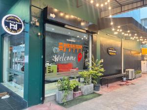 a store window with a welcome sign in it at DonMueang station hotel in Ban Don Muang (1)