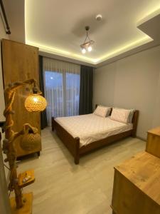 a bedroom with a bed and a chandelier at Merthous 19 in Atakum