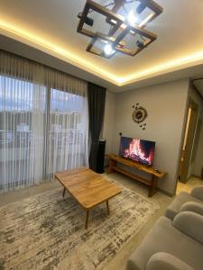 a living room with a table and a fireplace at Merthous 19 in Atakum