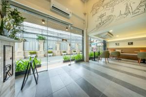 a lobby of a building with plants on the wall at Ralph Poshtel Sukhumvit in Bangkok