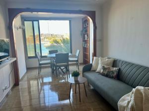 a living room with a couch and a table at Abora Mar - Beach Apartment in Patalavaca