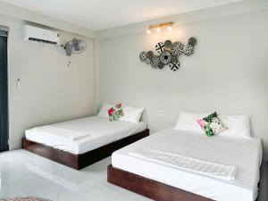 two beds in a room with white walls at Le Soleil Ba Vì in Ba Vì +18 photos