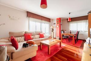 a living room with a couch and a table at Apartamento Plaza Perillana in Ponteareas