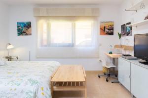 a bedroom with a bed and a desk with a computer at Apartamento La Higuera in Las Lagunas