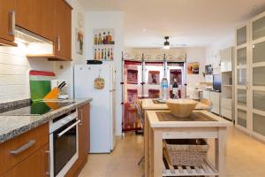 a kitchen with a white refrigerator and a table at Apartamento La Higuera in La Laguna