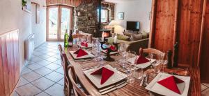 a dining room with a table with wine glasses at Chalet Dibona, cosy log fire evenings 200m from the slopes in Vaujany
