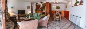 a living room with a couch and a table at Chalet Dibona, cosy log fire evenings 200m from the slopes in Vaujany