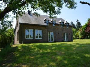 a large brick house on a grass field at Spacious villa near Lesse in Daverdisse
