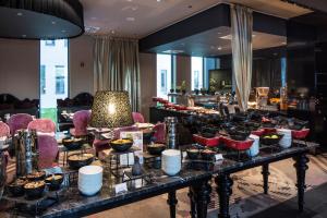 a buffet of food on a table in a room at Falkensteiner Hotel Belgrade in Belgrade