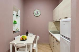 a kitchen with a white table and a white refrigerator at Guest House Le Tre Spezie in La Spezia