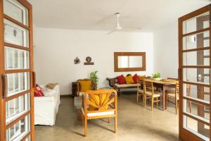a living room with a couch and a table and chairs at Colombo 07 Charming Home Stays in Colombo