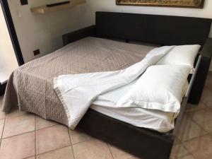 NovoliにあるMassimo Apartmentの黒枠のベッド、白いシーツ、枕