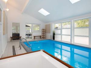 a large swimming pool in a house with at 12 person holiday home in Væggerløse-By Traum in Marielyst