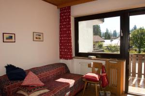 a living room with a couch and a window at Casa al Lago di Carezza - Dolomiti in Carezza al Lago