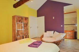 a room with a bed and a chair in it at Chambre d'Hotes de la Loge in Moussy