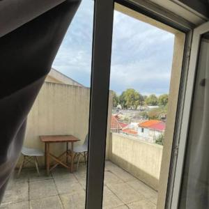 a view from a window of a balcony with a table at Blue Orange Porto Apart in Porto +9 photos