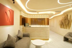 a waiting room with a couch and a counter at J Village Hotel - Triệu Việt Vương in Hanoi